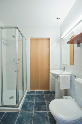 a bathroom with a toilet and a sink and a shower at Hostal la Salut de Terrades in Terrades
