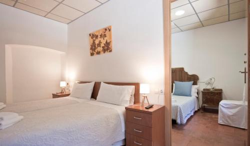a bedroom with two beds and a large mirror at Hostal la Salut de Terrades in Terrades