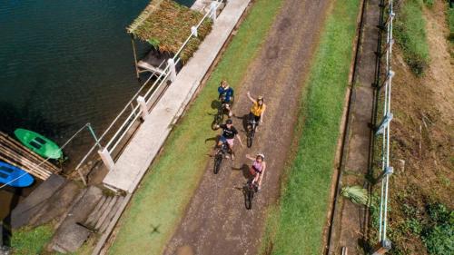 a group of people riding bikes on a bridge at Caliraya Ecoville Recreation and Farm Resort in Cavinti