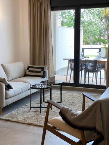 a living room with a couch and a table at MAR JÓNICA in Denia