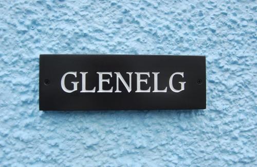 a black and white sign on a blue surface at Glenelg in Tobermory