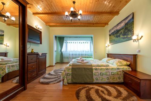Posteľ alebo postele v izbe v ubytovaní Pensiunea Turistică Vălari
