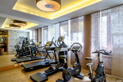 a gym with a row of exercise bikes and ellipticals at Insel Hotel Bonn - Superior in Bonn