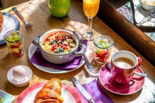 a table with a bowl of food and a cup of coffee at Insel Hotel Bonn - Superior in Bonn