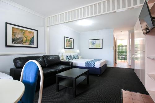 a living room with a couch and a chair at Toowong Central Motel Apartments in Brisbane