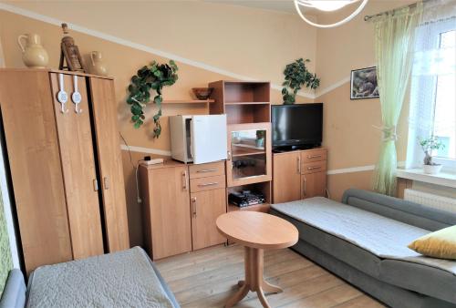 een kleine woonkamer met een bank en een tafel bij Noclegi u Eli in Świnoujście