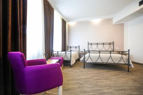 a hospital room with two beds and two chairs at Toplik in Sarajevo