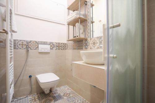 a small bathroom with a toilet and a sink at Toplik in Sarajevo