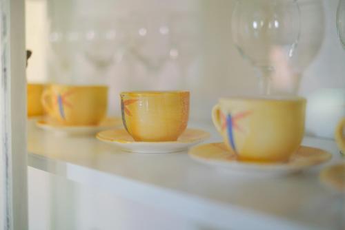 a row of orange cups and saucers on a counter at Apartment Jardin with free cowered parking in Zadar