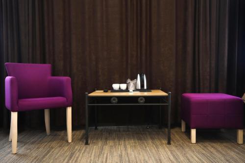 two purple chairs sitting next to a table with a purple chair at Toplik in Sarajevo