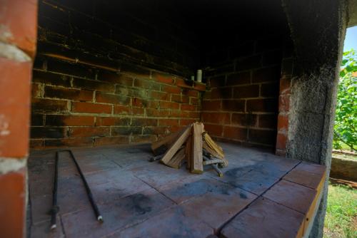 a room with a brick wall and a pile of wood at Apartment Jardin with free cowered parking in Zadar
