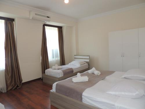 a hotel room with two beds and a mirror at Apartment on St. Nikoloz Baratashvili 1 in Batumi