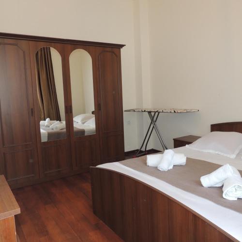 a bedroom with two beds and a large mirror at Apartment on St. Nikoloz Baratashvili 1 in Batumi