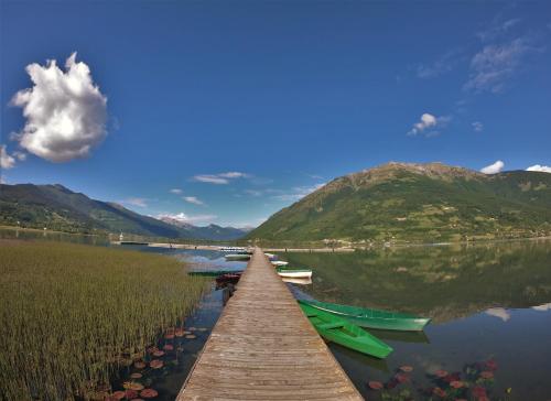 a dock on a lake with boats in the water at Guest House Blue Views in Plav