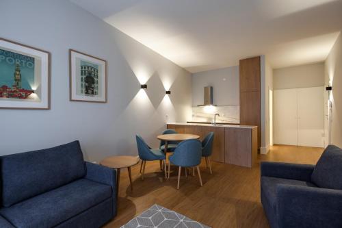 a living room with a couch and a table and chairs at Uma Formosa Apartments in Porto
