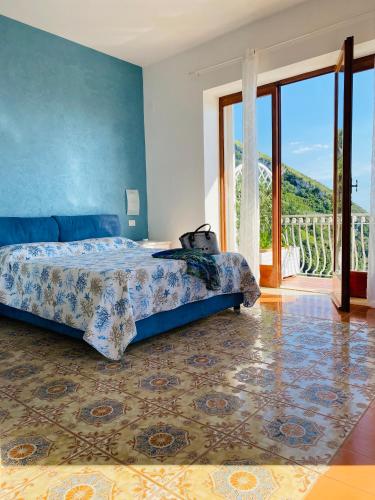 a bedroom with a bed and a large window at Acquamarina Accommodation in Massa Lubrense