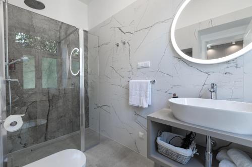a bathroom with a shower and a sink and a mirror at Green Park Luxury Rooms in Split
