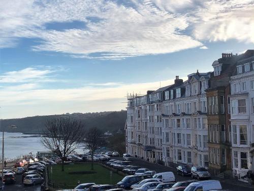 a parking lot with cars parked next to buildings at Harcourt Place in Scarborough