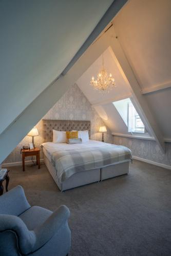 a bedroom with a large bed in a attic at Innishannon House Hotel in Inishannon