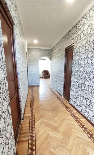 a hallway with blue and white walls and a wooden floor at EleGaya Guest house in Ijevan