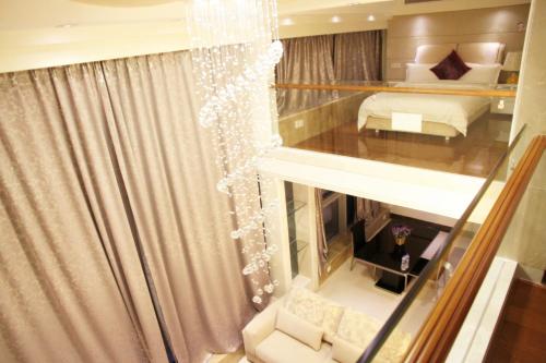 a view of a room with a bed and a window at Guangzhou Hakka Apartment Beijing Road in Guangzhou