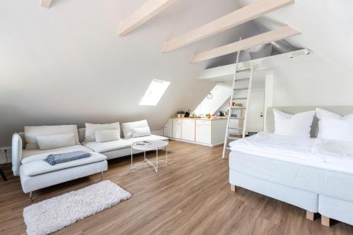 a bedroom with a bed and a couch and a ladder at Altstadt Apartments Verden in Verden