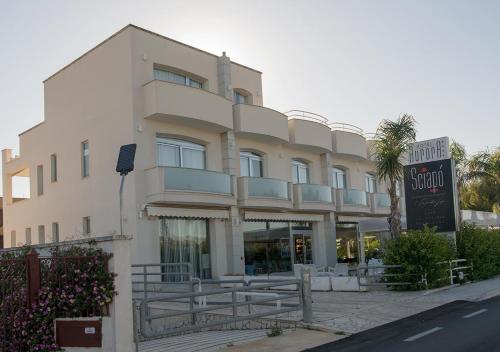 a building with a sign in front of it at Hotel Aurora in Porto Cesareo