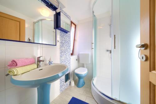 a bathroom with a sink and a toilet at Apartman ANTICA in Vantačići