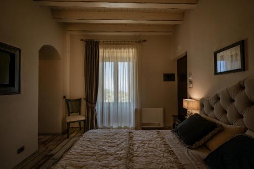 a bedroom with a large bed and a window at Donna Carolina Luxury rooms in Cefalù