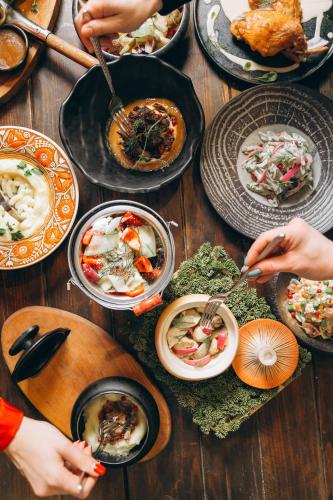 a table with many plates of food on it at Грибова хата in Bukovel