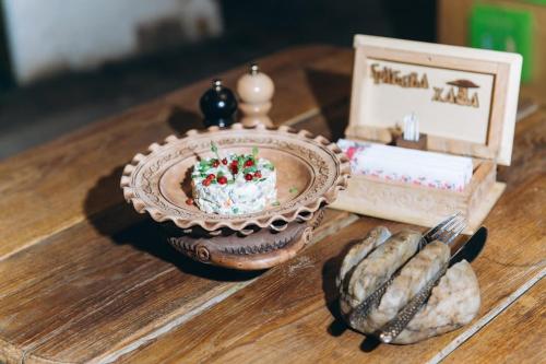 a table with a plate with a cake on it at Грибова хата in Bukovel