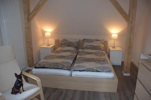 a bedroom with a bed with two lamps on the sides at Ferienwohnung Kröner in Donauwörth