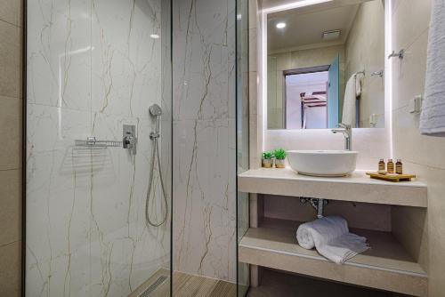 a bathroom with a sink and a shower at Aigli Villa in Zakynthos Town