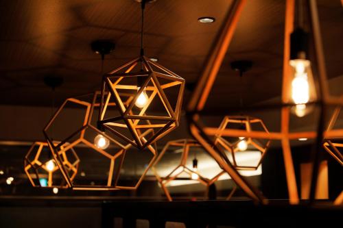 a group of lights hanging from a ceiling at JR Inn Hakodate in Hakodate