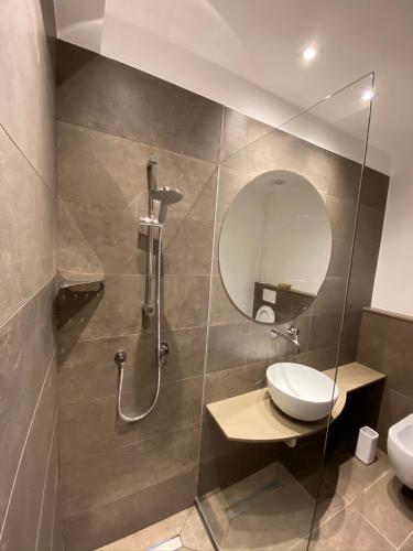 a bathroom with a shower and a sink and a mirror at B&B Moresco in Cattolica
