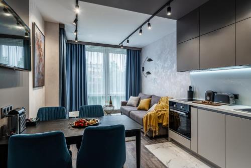a kitchen and living room with a couch and a table at LINKS apartments in Saint Petersburg