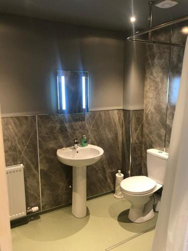 a bathroom with a sink and a toilet at Kilmorie House in Elgin