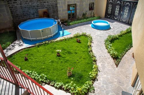an aerial view of a garden with a hot tub at Tatev Hotel and Tours in Yerevan