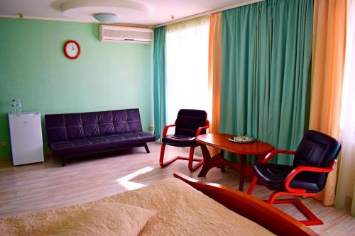 a living room with a couch and chairs and a table at Hotel Complex Vizit in Kozin