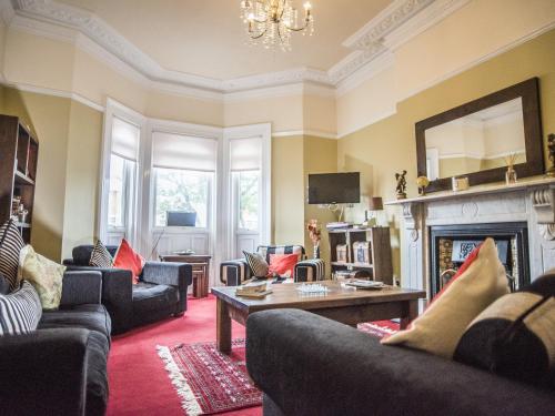 a living room with couches and a fireplace at Baytrees Hotel in Southport