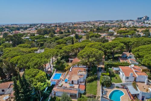 an aerial view of a mansion with a pool and trees at Villa Namibe na Quinta da Balaia in Albufeira