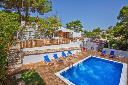 a swimming pool with lounge chairs and a swimming pool at Villa Namibe na Quinta da Balaia in Albufeira