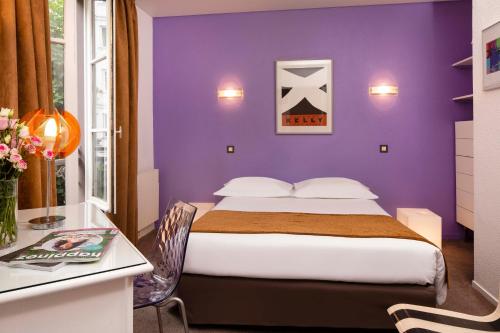 a purple bedroom with a bed and a desk at Le Hameau de Passy in Paris