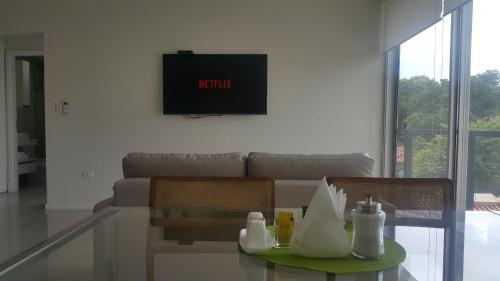 a living room with a couch and a glass table at START Villa Morra Rent Apartments in Asuncion
