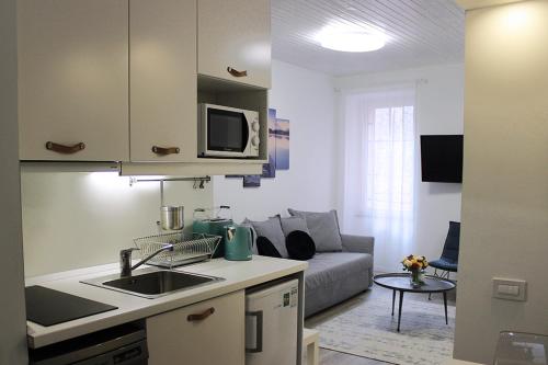 a kitchen and a living room with a couch at Love Apartment Rovinj in Rovinj