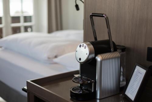 a hotel room with a heater on a table next to a bed at Boutique Hotel Aichinger in Nussdorf am Attersee