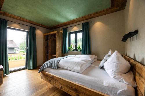 a bedroom with a bed and a large window at Gästehaus Richter in Grainau