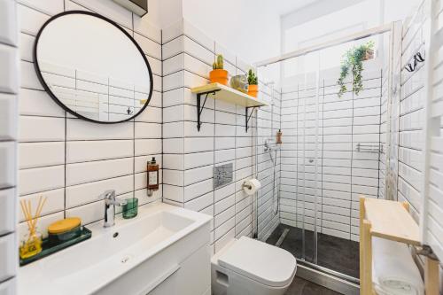 a bathroom with a toilet and a sink and a mirror at BOHO HOUSE in Ustrzyki Dolne