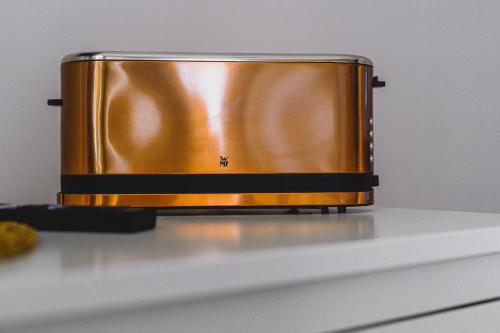 a gold toaster sitting on top of a counter at BOHO HOUSE in Ustrzyki Dolne