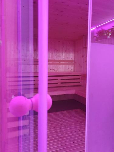 a pink bathroom with a pink bench in a room at Hotel Villa Chiara in Terracina